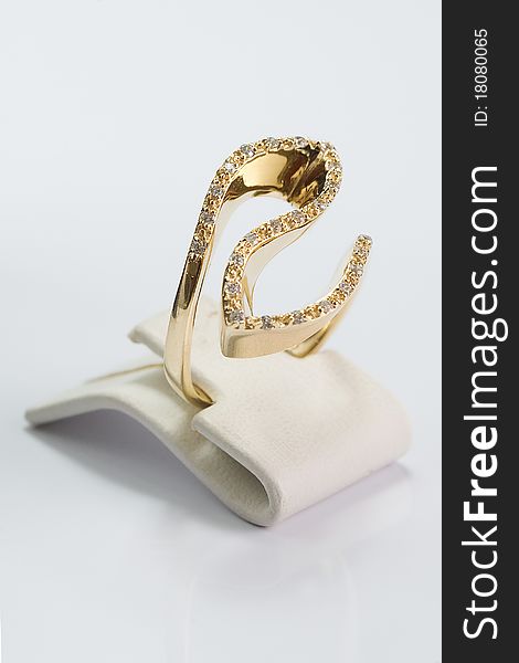 Gold ring with clear stones on white