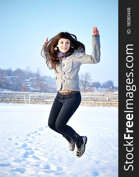 Beautiful Jumping Girl outdoors in winter time