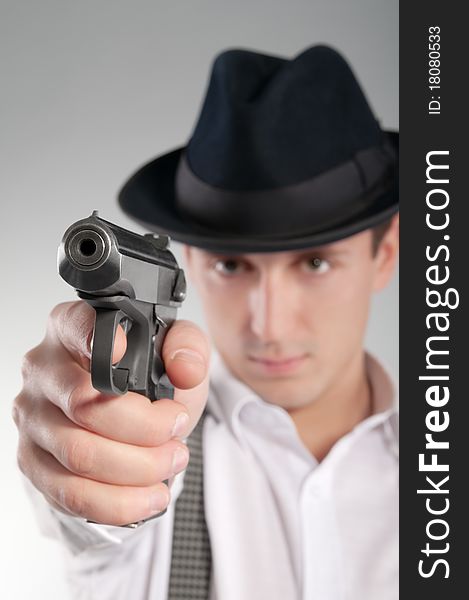 Dangerous Gangster In Hat Aims A Pistol