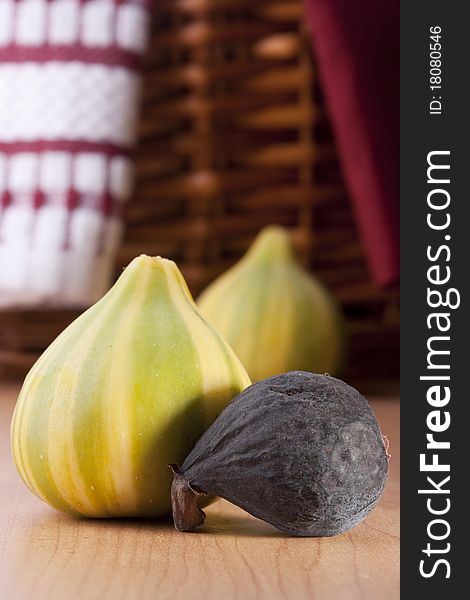 Ripe fruits of a fig on a wooden table.