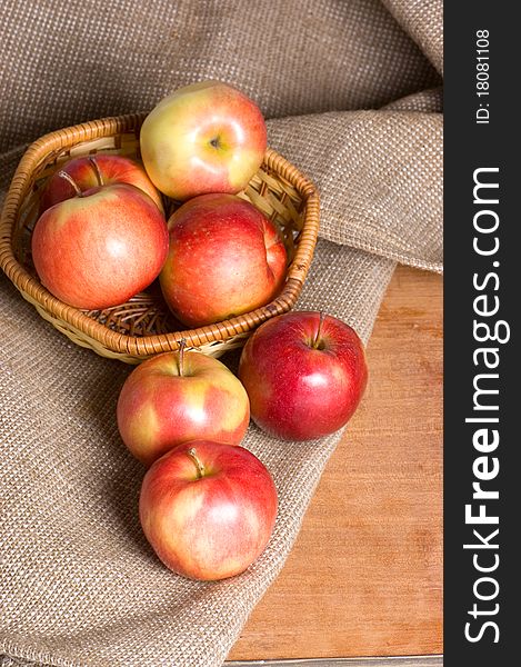 Apples on a sacking on a wooden table still life