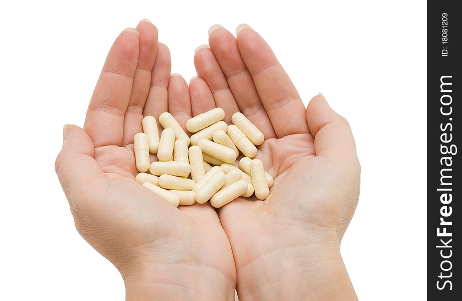 Hand with a pill on white background