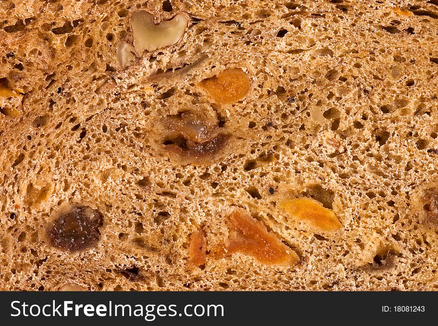 Cut bread with raisin and dried apricots close up