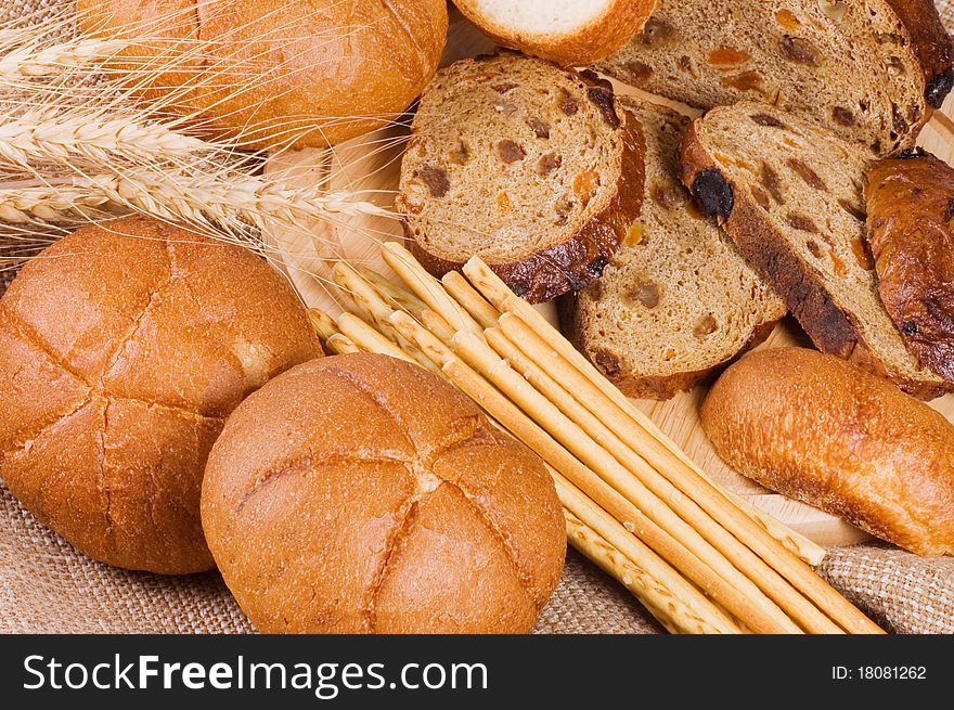 Fresh bread with ear of wheat close up