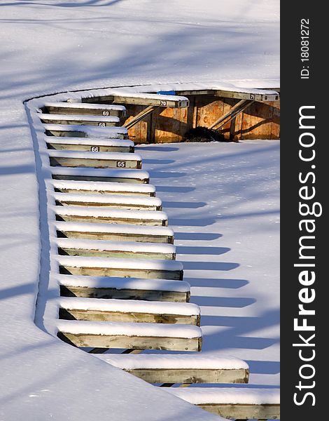 Snow covered empty boat dock in the winter time