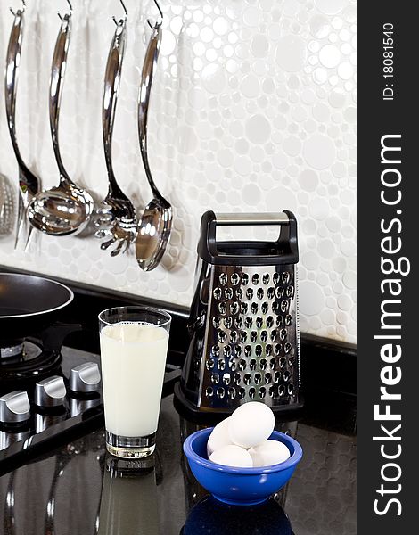 Background of modern kitchen and eggs, milk and grater