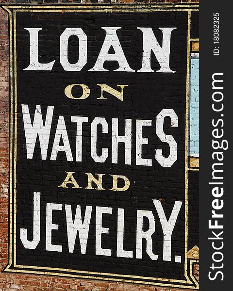 Loans on watches and jewelry old painted sign on the side of a building in the Pueblo, CO historic Union station district.