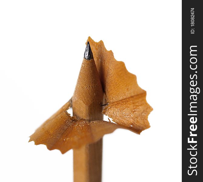 Wooden natural brown sharpened pencil with shavings.