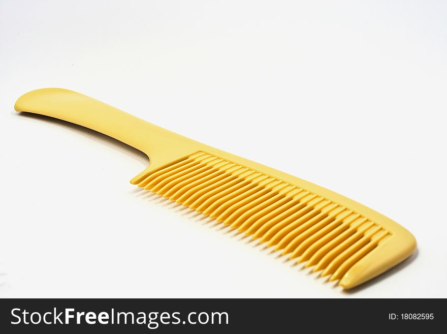 A yellow comb is isolated in this picture