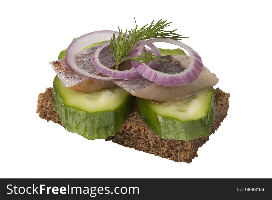 Danish open sandwich with onion rings, herring and cucumber, on a dark rye bread. Isolated on a white background.