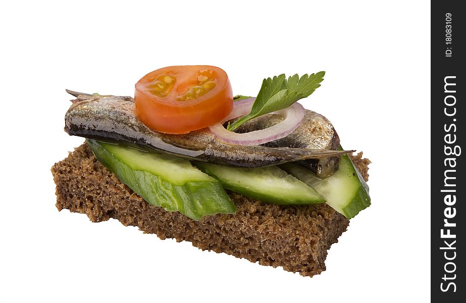 Danish open sandwich with sprat,  tomato and cucumber,  on a dark rye bread. Isolated on a white background.