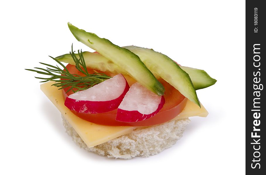 Danish open sandwich with tomato,  radish, cheese  and cucumber,  on white bread.