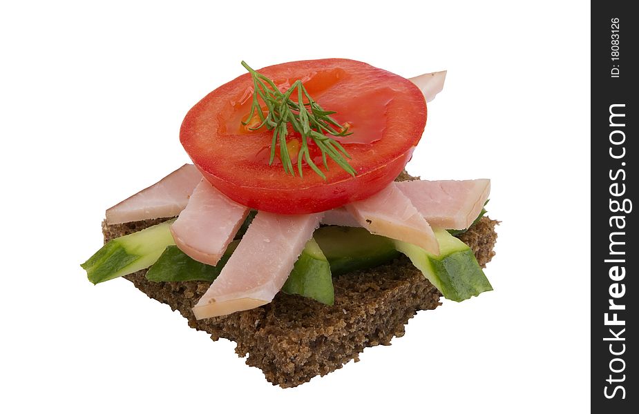 Danish open sandwich with ham, tomato and cucumber,  on a dark rye bread. Isolated on a white background.