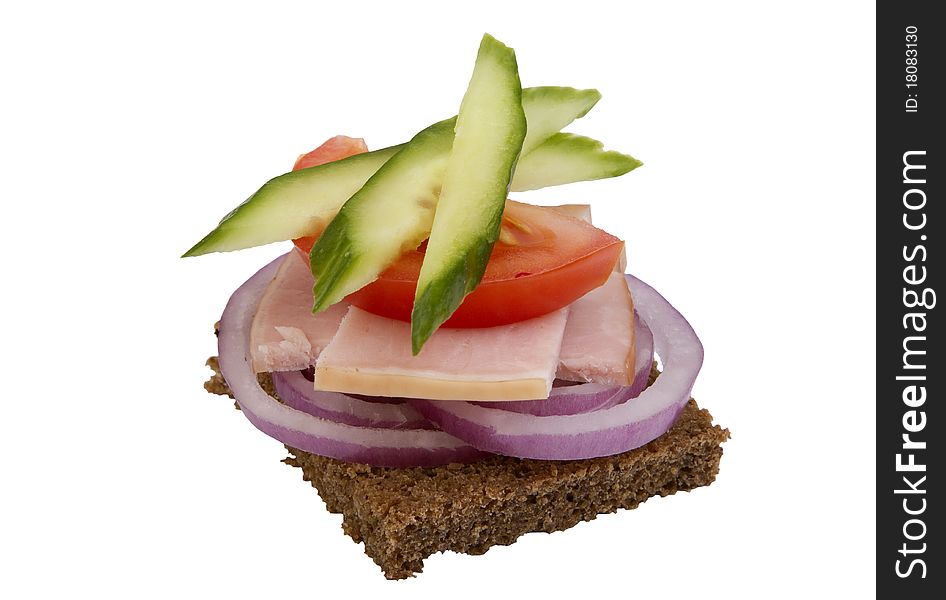 Danish open sandwich with onion rings,  ham, tomato and cucumber,  on a dark rye bread. Isolated on a white background.