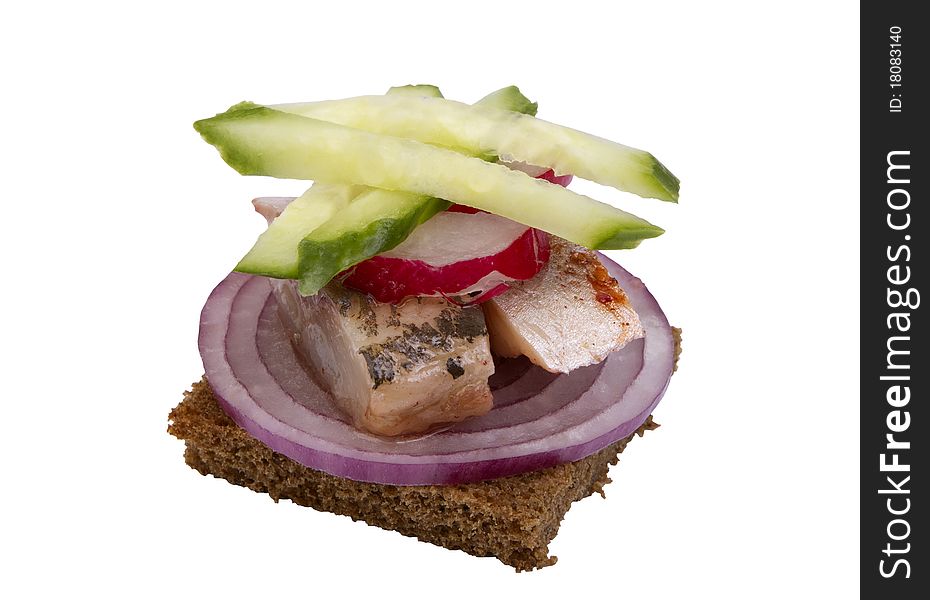 Danish open sandwich with onion rings, herring and cucumber, on a dark rye bread. Isolated on a white background.