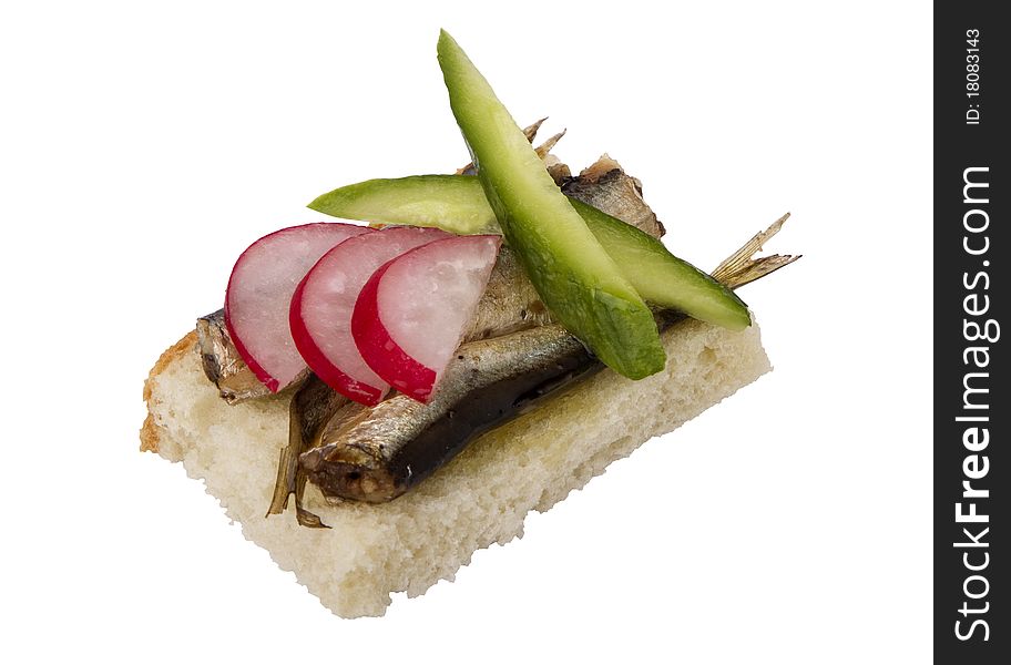 Danish open sandwich with sprats, radish and cucumber, on white bread.