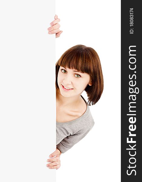 Young smiling woman holding blank billboard sign isolated on white