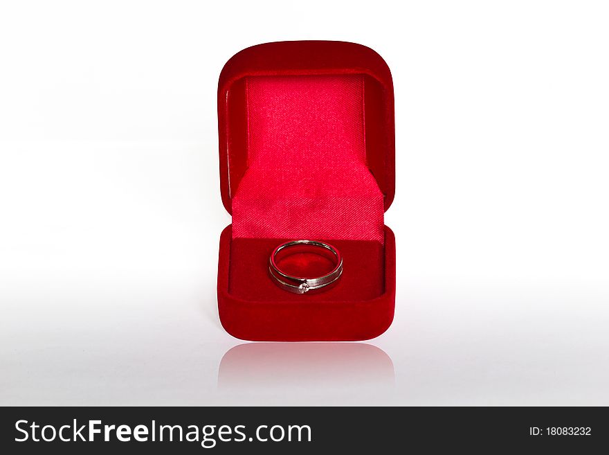 Ring in open red velvet box isolated on white background
