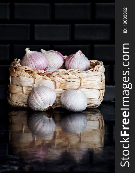 Garlic bulbs in small basket. Garlic bulbs in small basket