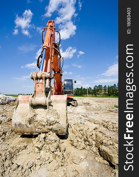 Excavator stopped near a construction site