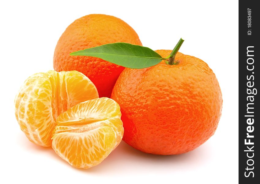 Tangerines entirely and segments and with leaves close up. Tangerines entirely and segments and with leaves close up