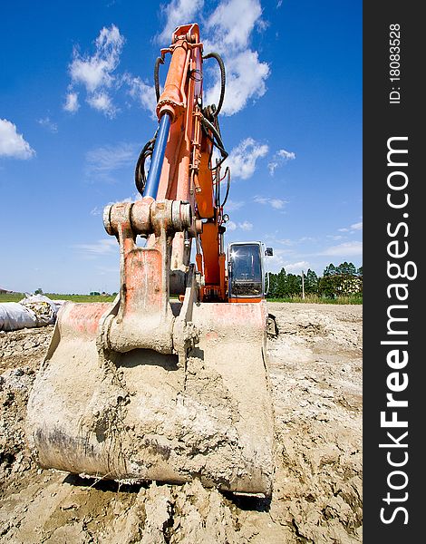 Excavator stopped near a construction site