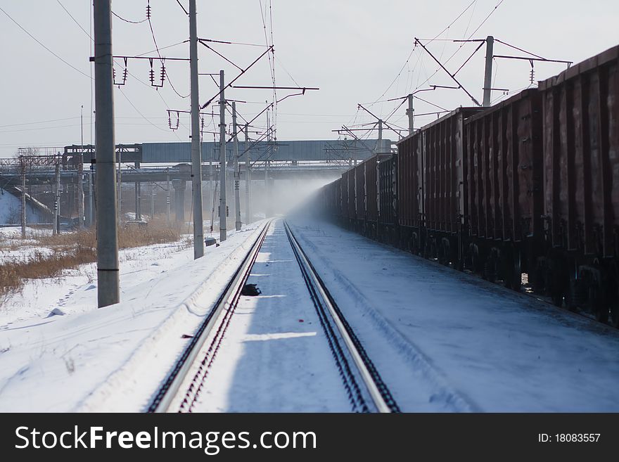 Moving cargo train at sunny winter day
