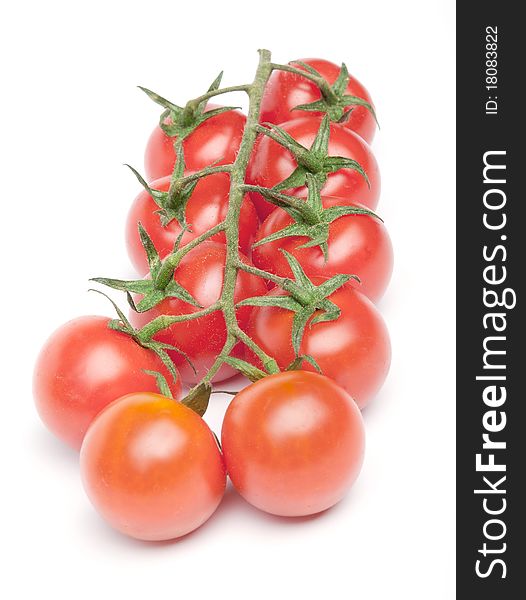 Ripe red cherry tomatoes on the branch.