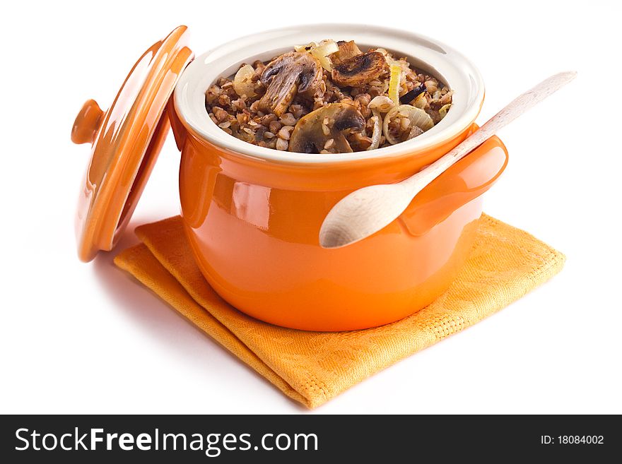 Buckwheat with mushrooms in a pot on a white background. Buckwheat with mushrooms in a pot on a white background