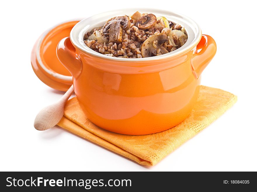 Buckwheat with mushrooms in a pot on a white background