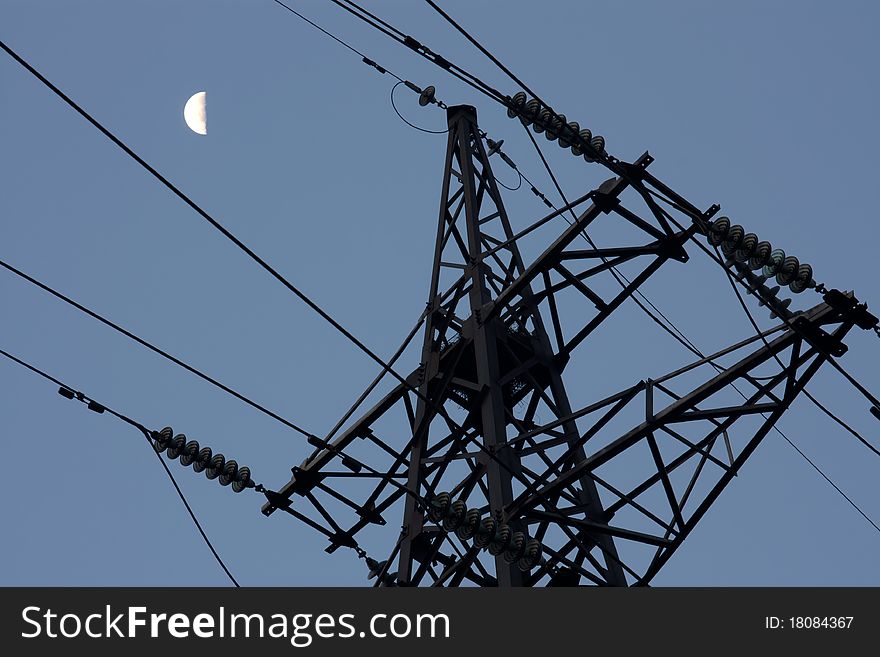 Old column with wires on a background of the sky