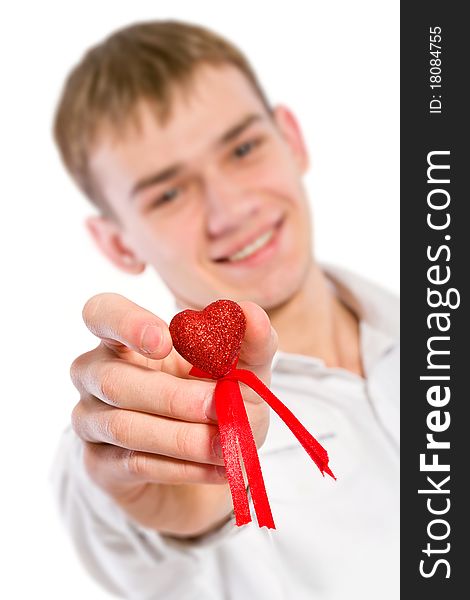 Young man holding heart in his hand. He is giving it somebody. Isolated on white.