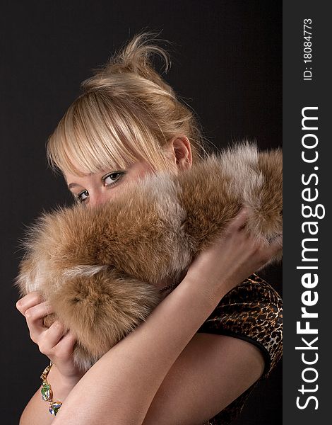 Girl covered her face with fur. Girl covered her face with fur