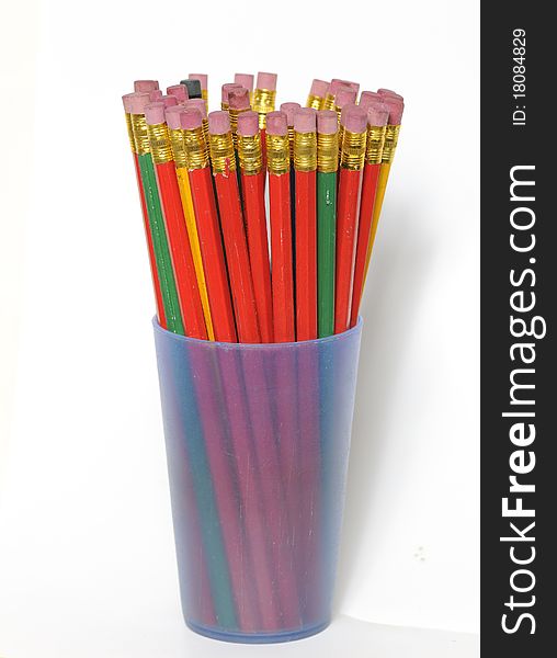 Set of pencils with eraser in a vase on a white background