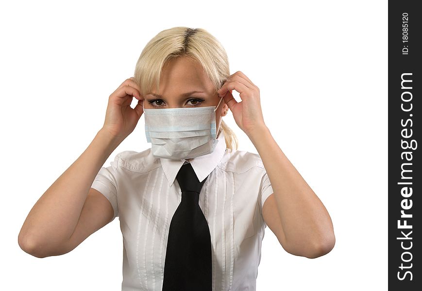Blonde girl wearing surgical mask against white background. Blonde girl wearing surgical mask against white background.