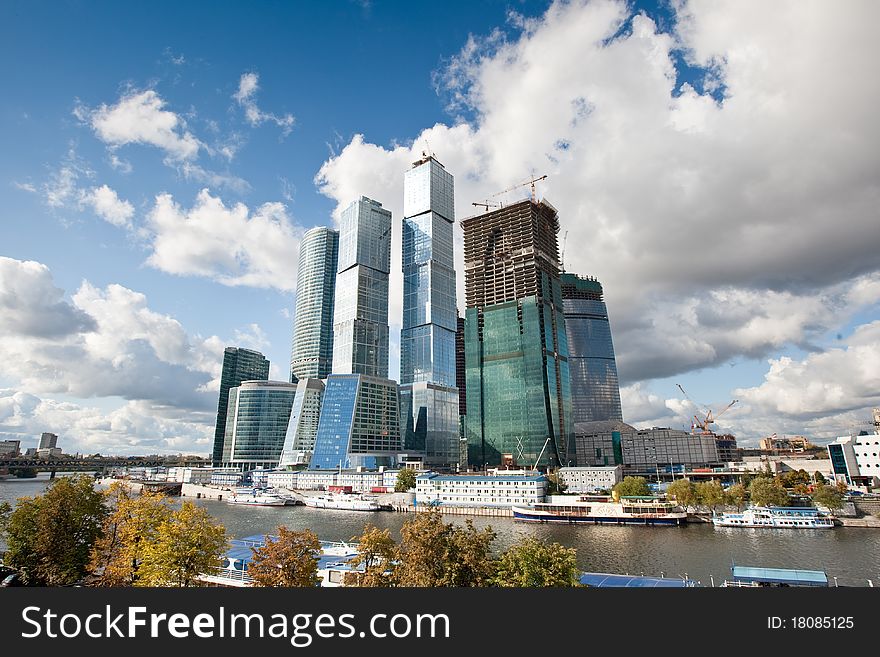 Many scyscrapers of Moscow city under blue sky with clouds