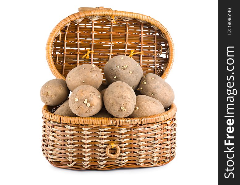 Raw potatoes in a basket isolated on white background