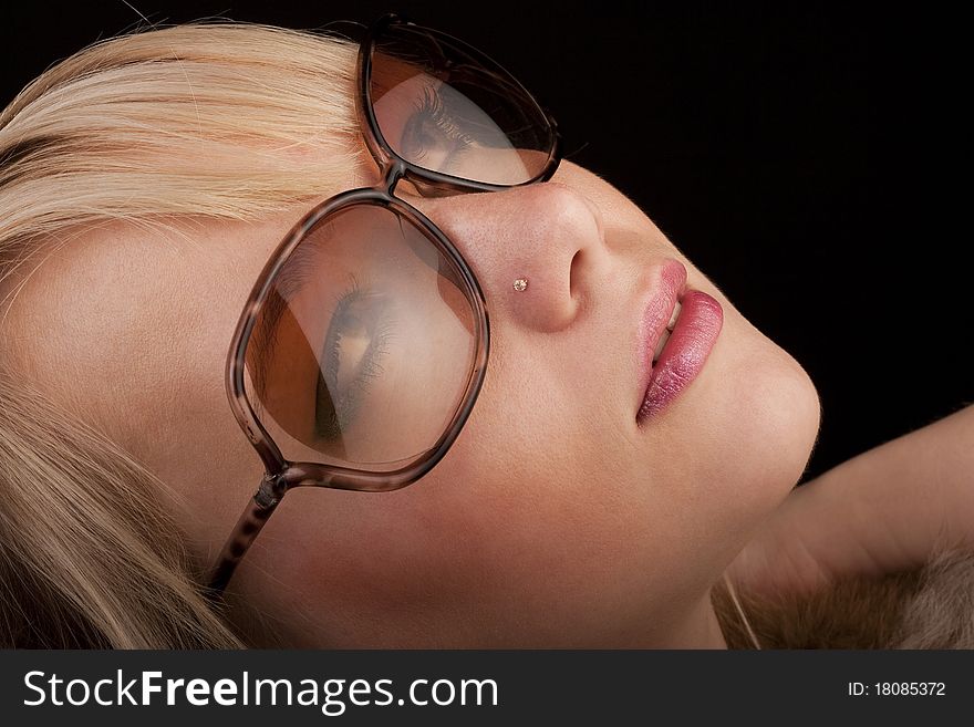 Girl in glasses posing to the camera