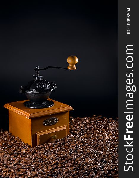 Coffebeans and grinder on a black background