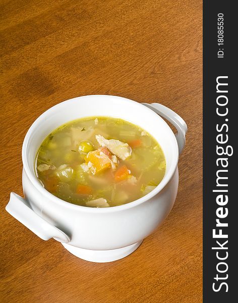 White porcelain bowl of chicken soup with veggies. White porcelain bowl of chicken soup with veggies.