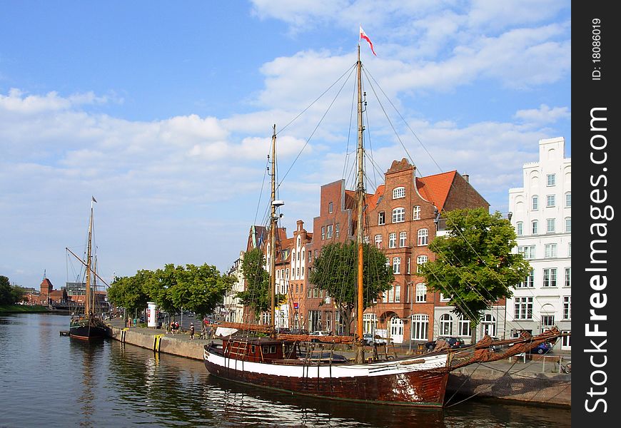 Old wooden sailboats on the river in the German city of Luebeck