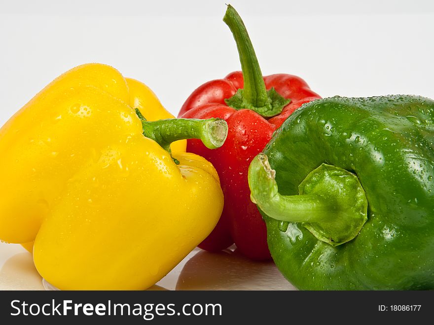 Wet bell peppers on a white background