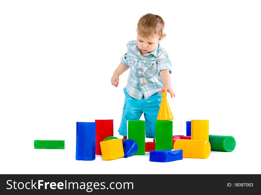 Cute little baby boy with colorful building blocks isolated on white