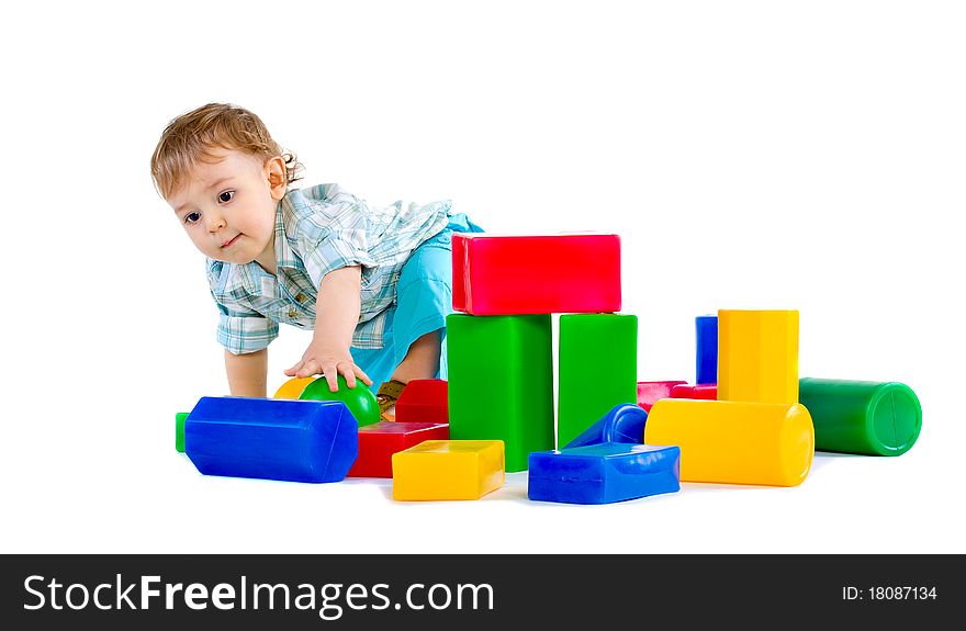 Cute little baby boy with colorful building blocks isolated on white