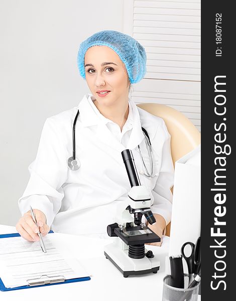 Medical - Female nurse looking in microscope