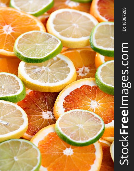 Slices of orange, lemon and lime - background