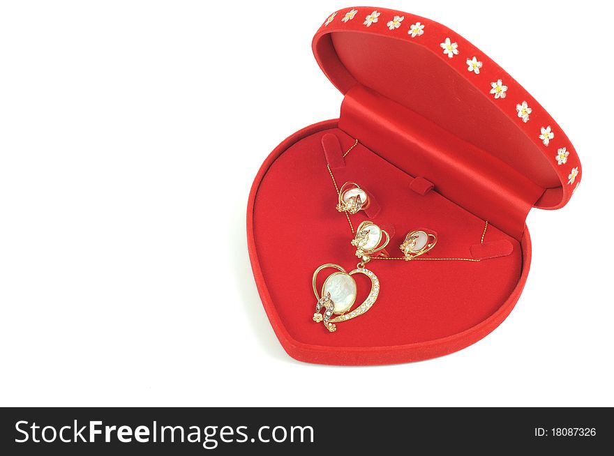 Gold jewelry set with pearls in red open box. Gold jewelry set with pearls in red open box