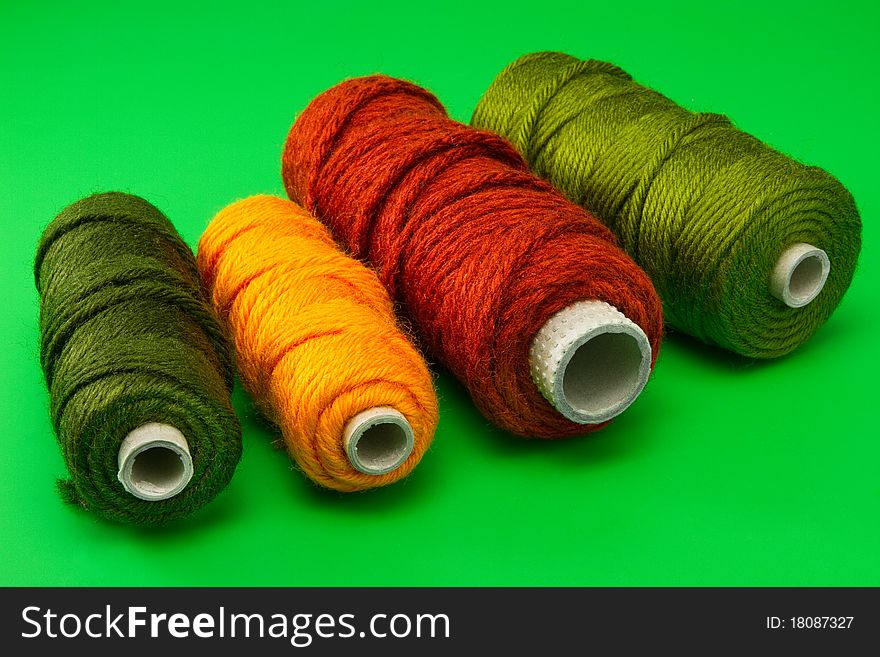 Bobbin Of Thread With Colorful Threads In A Row