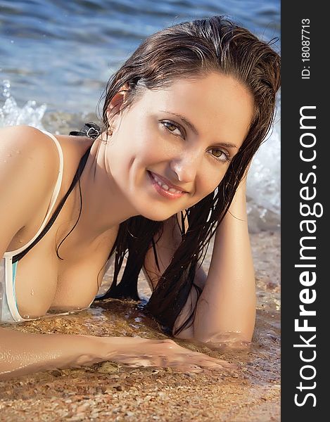 Young beautiful girl on the beach in a bikini, portrait close up