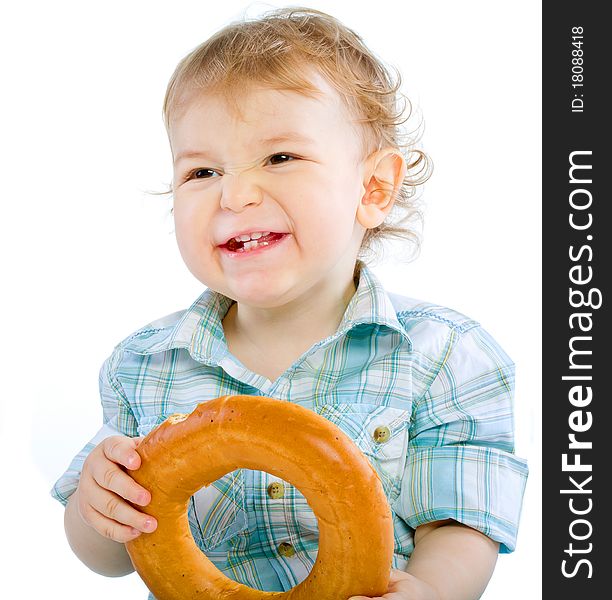 Little baby boy holding a bagel over white isolated